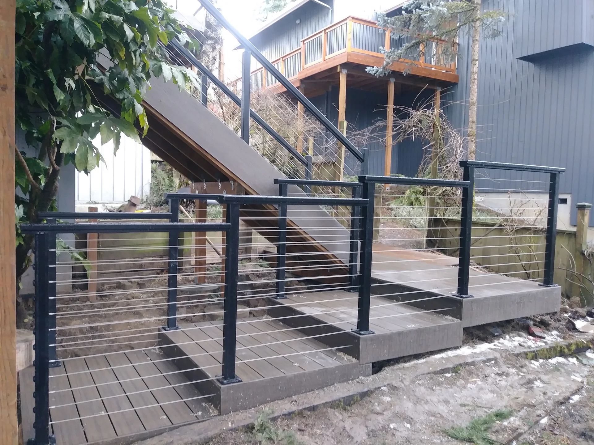 Deck and cable railing by Adrian's Quality Fencing and Decks