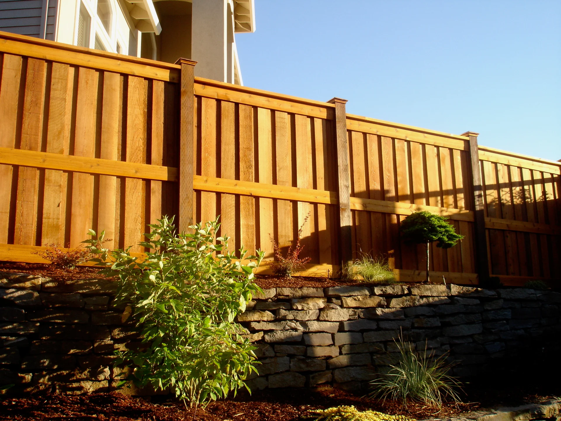 Neighbor-side cedar finish by Adrian's Quality Fencing and Decks
