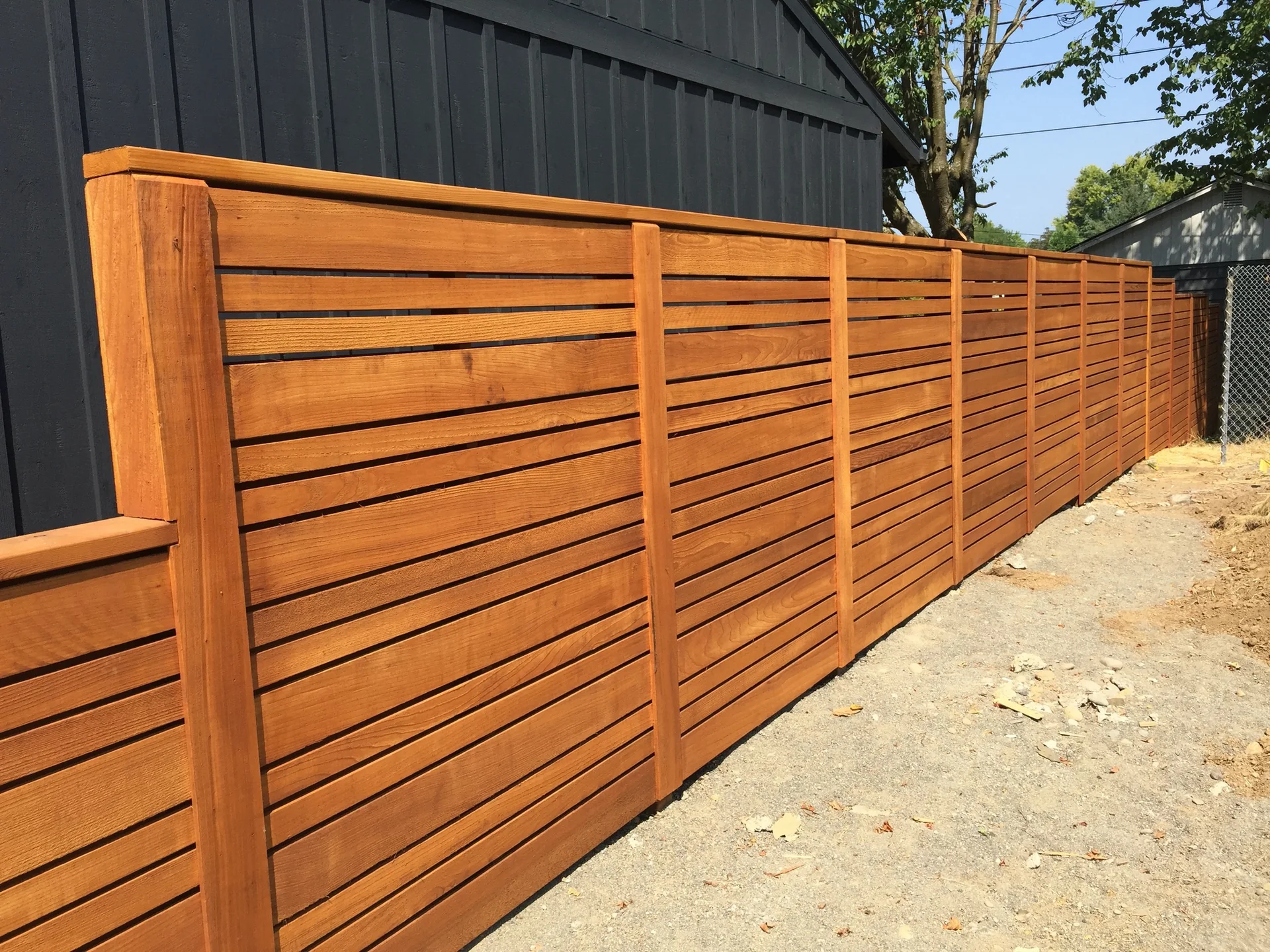 Stained horizontal cedar by Adrian's Quality Fencing and Decks