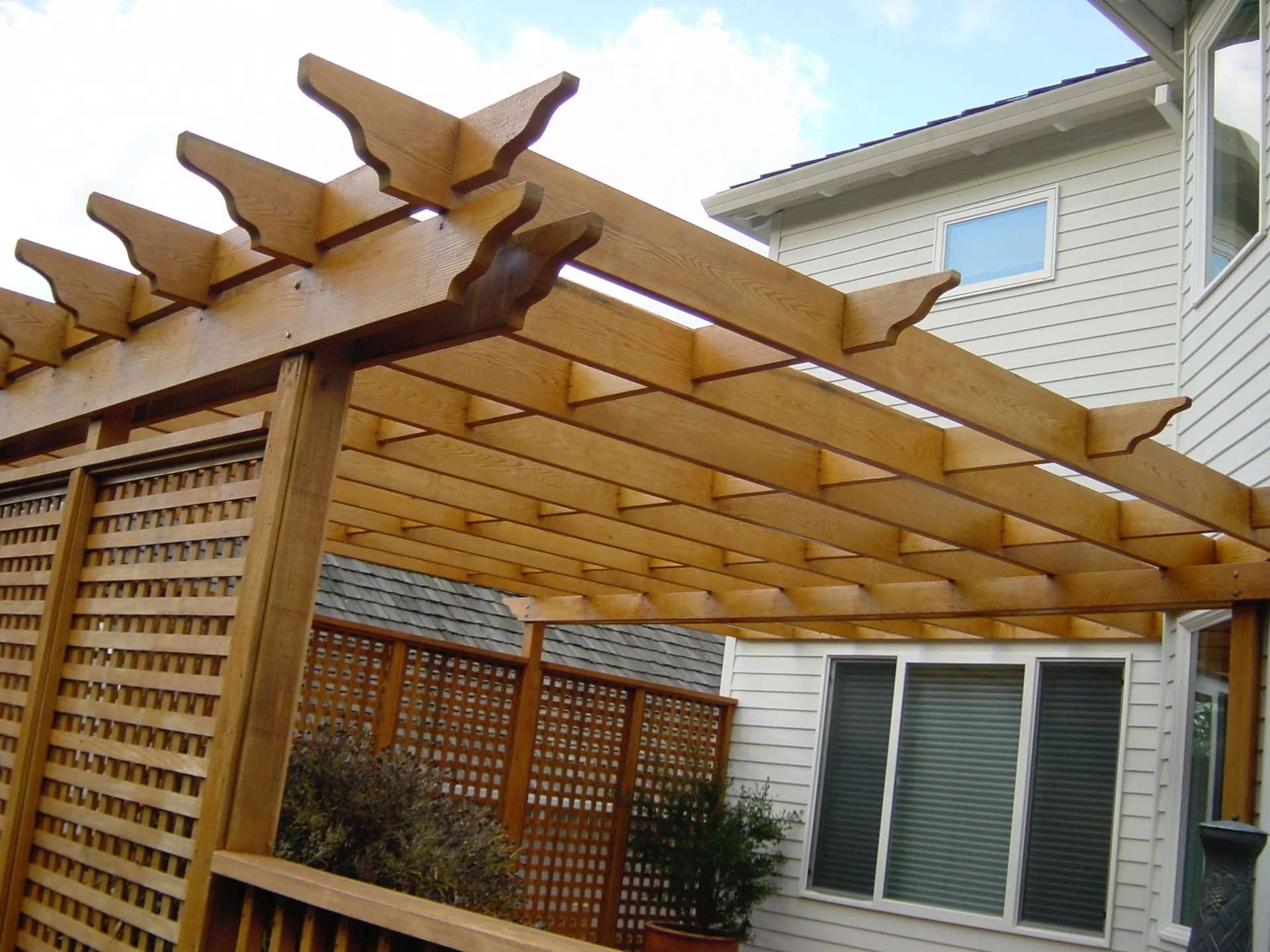 Cedar trellis extending from the side of a home