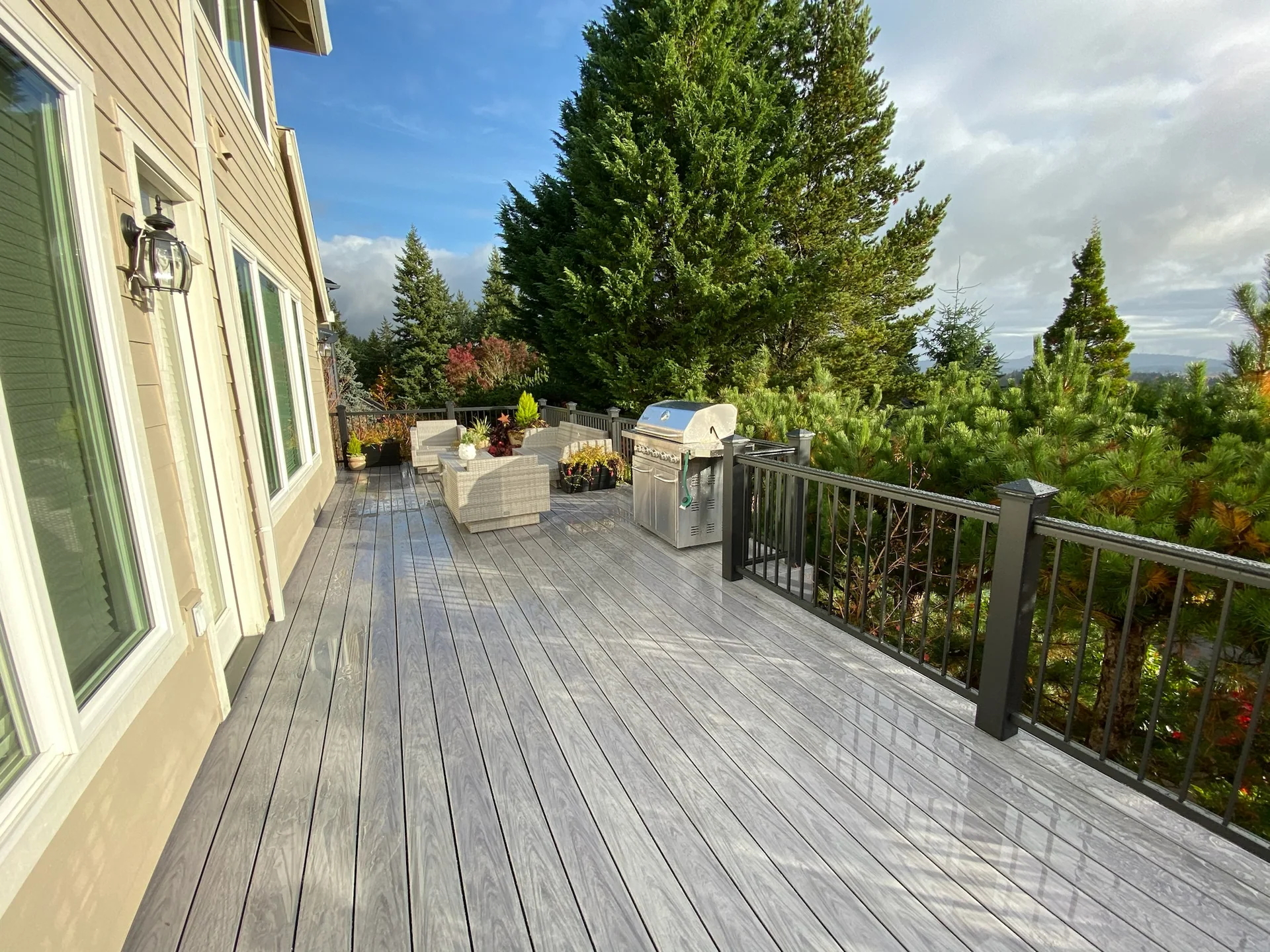 Finished composite deck with black railing and room for outdoor seating
